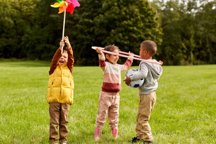 Three children play outside.